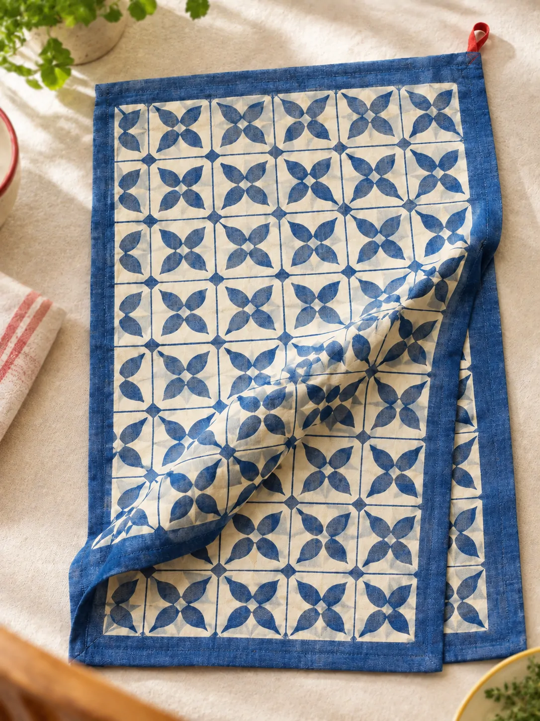 Blue Tile Tablecloth close up: edge finish and red corner loop