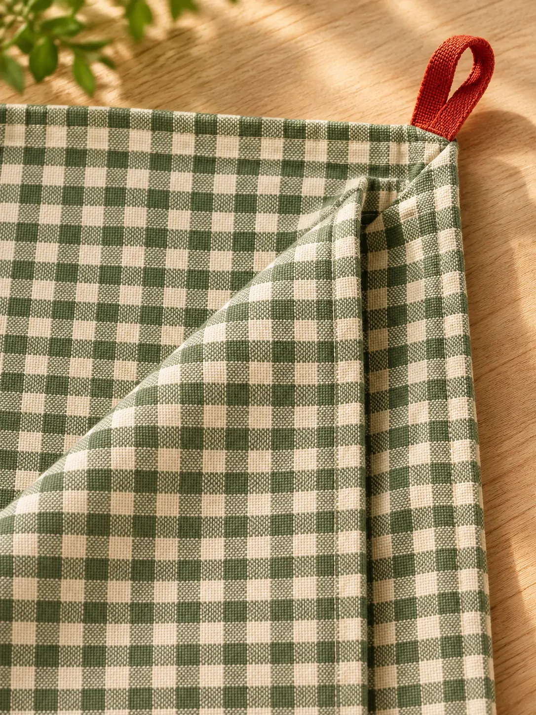 Café Check Tablecloth close up: edge finish and red corner loop