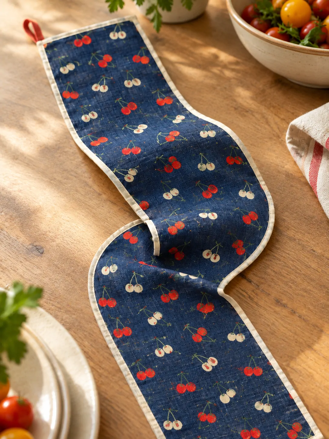 Cherry Market Table Runner close up: edge finish and red corner loop